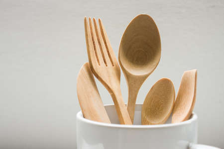 Brown Wooden Spoon In Cup On White Background.
