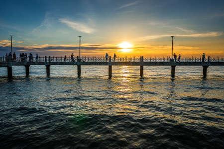 Bangsaen, Chonburi, Thailand - July 31, 2016: Fishing Man On The Bridge At Sunset  Background.のeditorial素材