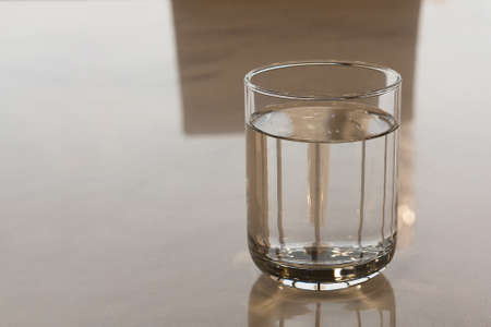 Glass Of Water On The Table In Office Worker.