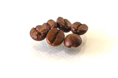 Roasted Coffee Beans Scattered Isolated On White.の写真素材