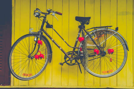 Image View Of Vintage Bicycle Decorate On Yellow Wall.