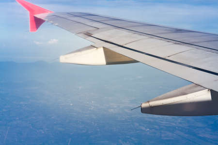 Wing Of Plane With Sunlight And Clouds View From Window On The Airplane.の写真素材