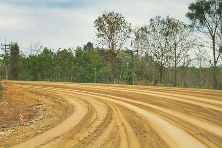 A Long Roads Curved Narrow Trench Made In The Ground By Wheel Car.の写真素材