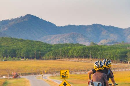 Image Rear Of Biker With Helmet Cycling In The Park.のeditorial素材