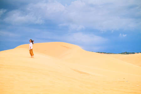 Mui Ne, Vietnam - May 26: Unidentified People In Sunny Day With Blue Sky And Clouds On Sand Dune (White Desert) On May 26, 2017 In Mui Ne Vietnam.のeditorial素材