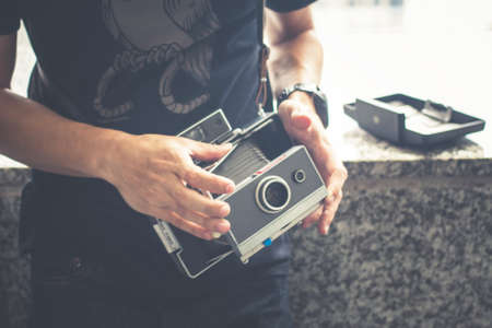 Close-Up Hands Of A Man With Old Classic Camera.の写真素材