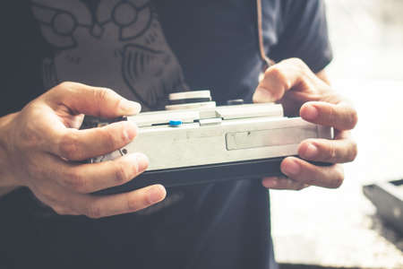 Close-Up Hands Of A Man With Old Classic Camera.の写真素材