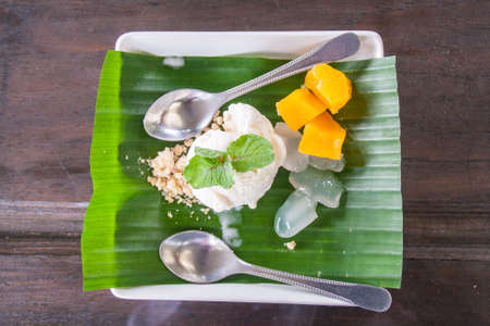 Fresh Coconut Ice Cream Is Placed On Green Banana Leaves In A White Dish.の写真素材