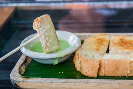 Steamed Custard Toast On Wooden Plate Background.