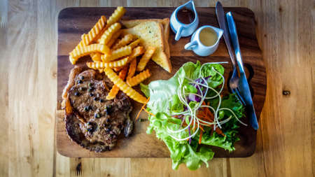 Grilled Beef Black Pepper Steak Medium Rare On Wooden Cutting Board.の写真素材