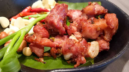 Deep-Fried Fermented Pork Ribs On Banana Leaf In Black Dish.の写真素材