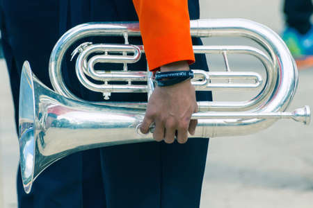Close-Up View Of Musician Hand Holding With Silver Trumpet Musical Instrument.の写真素材