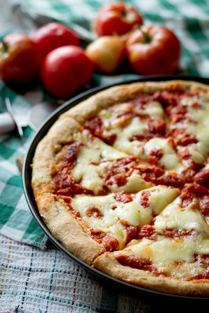 Delicious pizza with tomatoes and mozarellaの写真素材