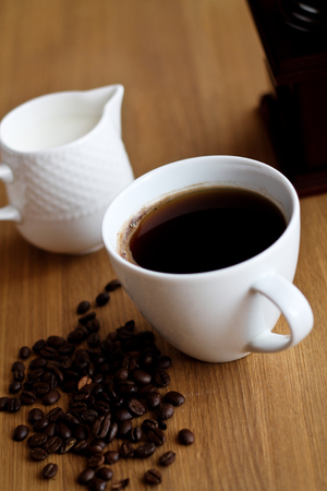 Aromatic fresh coffee in porcelain cup on wooden tableの写真素材
