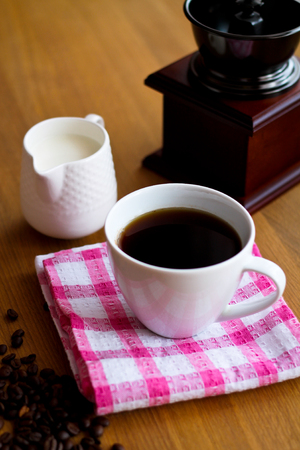 Aromatic fresh coffee in porcelain cup on wooden tableの写真素材