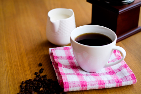 Aromatic fresh coffee in porcelain cup on wooden tableの写真素材