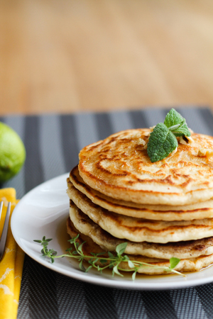 Fresh, delicious pancakes with walnuts on wooden tableの写真素材