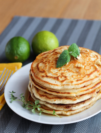 Fresh, delicious pancakes with walnuts on wooden tableの写真素材