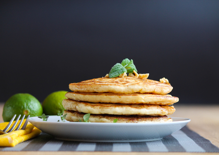 Fresh, delicious pancakes with walnuts on wooden tableの写真素材