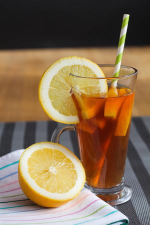 Lemon tea in glass on wooden tableの写真素材