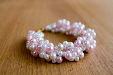 Pearl bracelet on wooden tableの写真素材