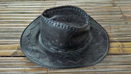 hat black . hat black place on a bamboo backgroundの写真素材