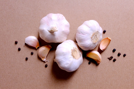 Garlic clove and blub on brown backgroundの写真素材