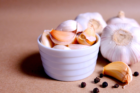 Garlic clove and blub on brown backgroundの写真素材