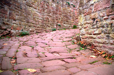 Narrow alley made of red sand stonesの写真素材
