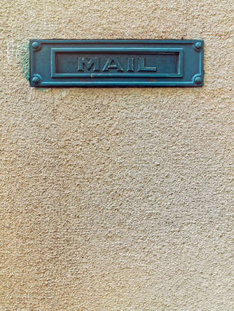 Metallic green frame with the word "mail" on the background of the old wallの写真素材