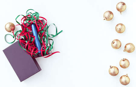 Blue vibrator in a gift box with colored ribbons. Around the gift are Christmas decorations. Image for the festive season, for sales and discounts in sex shops. There is a free space for textの写真素材