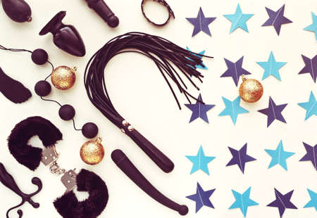 Various sex toys and Christmas decorations. New Year or Christmas background with blue stars. Image for the festive season, for sales and discounts in sex shopsの写真素材