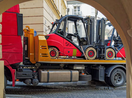 Prague, Czech Republic - April 21, 2017: A car tractor with small forklift trucks leaves the street (ValdÅ¡tejnskÃ¡) into the courtyardの写真素材