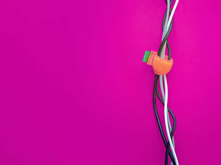 Laying various cables (electricity, data, communications, telephony, the Internet). Fastening cables with Velcro tape. Repair cable works at home or in the office.の写真素材