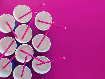 Straws for drinks are in empty blue paper cups. Waiting for the festival, parties, events. There is space for text. Artistic increase in the level of color and noiseの写真素材
