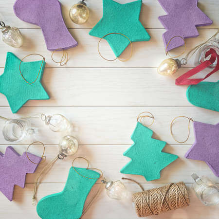 Christmas composition. Paper Christmas tree decorations, small glass balls and a reel with a rope...