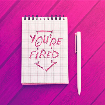 Notepad with text in red. Nearby is a white pen. Concept of the crisis, unemployedの写真素材