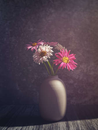 A bouquet of colorful daisies in a vase. Stone background.の写真素材