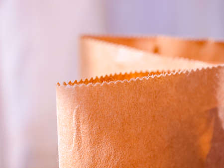 Close view of a paper shopping bag. Shallow depth of field. Visible texture and fiber paper. The...