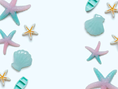 Creative travel background. Layout of various sea figures (starfish, boats, shells). Preparing for vacation and travel. Flat lay. Copy space.の写真素材