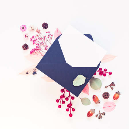 Autumn concept. A blank sheet of paper is in a black envelope. The template is decorated with red...