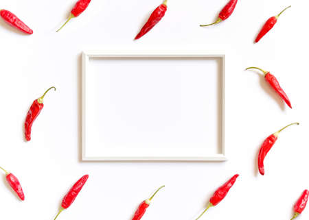 Vegetable composition. The fruits of the red hot pepper are around a white frame on a white...