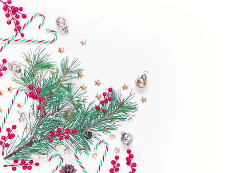 The natural pine branch is decorated with red berries, gold stars, candies and glass balls....