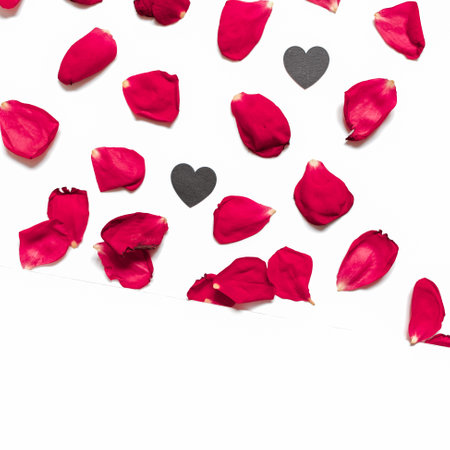 Rose petals and heart-shaped confetti are on a white background. Floral layout for valentine's day, birthday, wedding invitation. Flat lay. Top view. Copy space.の写真素材