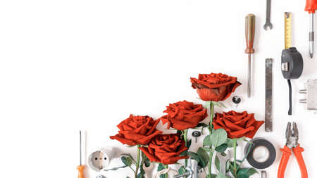 Flower layout for Labor Day, May Day, Father's Day. Red roses and various tools (screwdriver, wire...