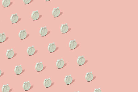 The pattern is made of brightly lit green alarm clocks on a pink background. Abstract trendy...
