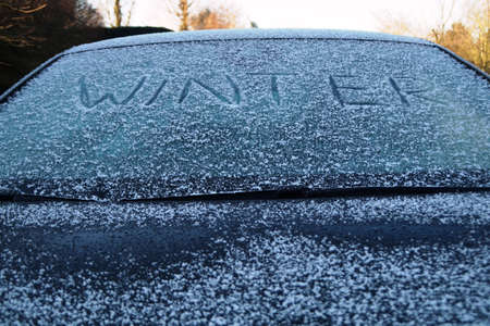 Become a 'winter' written on a frozen car windowの写真素材
