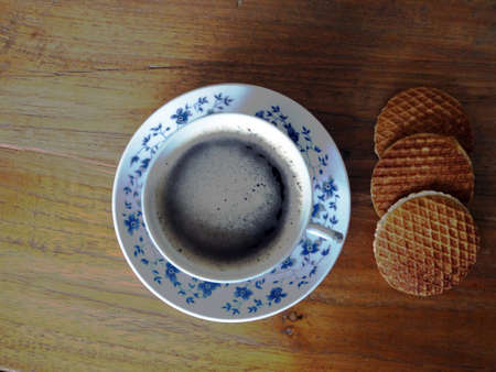 Delft blue cup of coffee with cookiesの写真素材