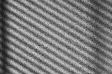 White and gray wall with dark diagonal stripes background with rough textureの写真素材