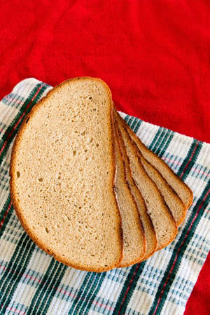 Slices of bread stacked on a red green white background. Selective focusの写真素材